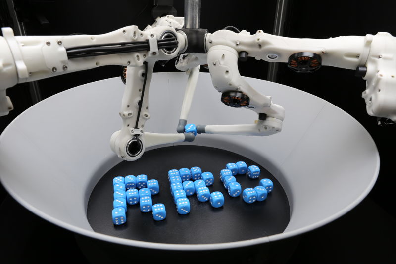 TriFinger robot with dice forming the letters RRC.